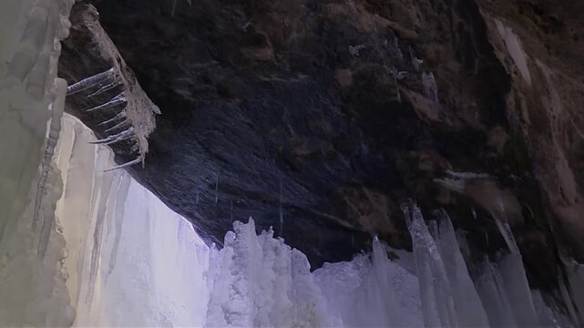 Ice Cave Melting Icicles In Eben Ice Caves, Michigan, USA - Low Angle Shot