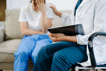 Obraz premium Doctor comforting patient with pain and stress during consultation, showing healthcare, empathy, support, and professional medical care.