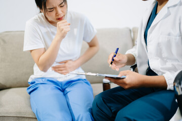 Doctor giving medication to patient suffering from stomach pain, showing healthcare, diagnosis, and medical treatment in a clinical consultation setting.