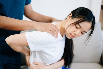 Fototapeta premium Male Doctor and patient suffering from back pain during medical exam.