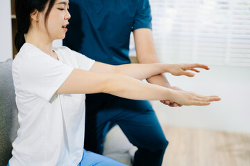 Fototapeta premium Healthcare professional helping patient with arm rehabilitation exercise, showing injury recovery, physical therapy care