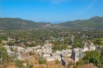 Fototapeta premium Fethiye Kayaköy stone houses and ruins. Mugla, Turkey. Kayakoy ghost village. Turkey's abandoned houses. The Ghost Town of Kayakoy. Abandoned religious ghost city.