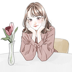 両手で頬杖をつく女性