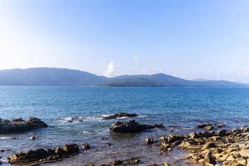 peaceful coastal landscape with rocks and infinite sea in evening