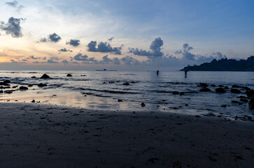 calm ocean water beach vibes and silhouette sunrise at dawn
