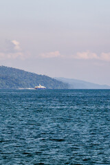 scenic ocean view with distant forested island and calm waters at sunrise