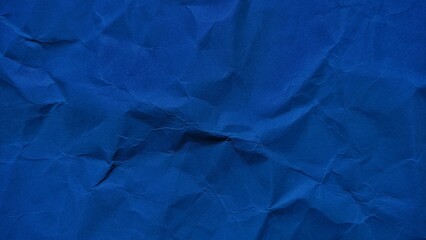 Wrinkled dark blue paper background with soft wave texture. Crumpled blue vintage paper surface texture for background. Wrinkled paper background with copy space for text.