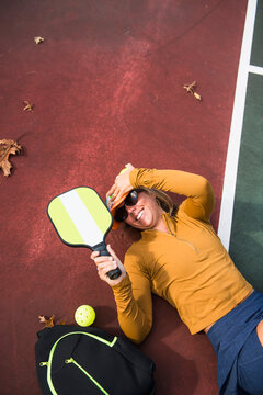 Woman on the pickleball court in autumn