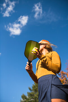 Woman playing pickleball in autumn