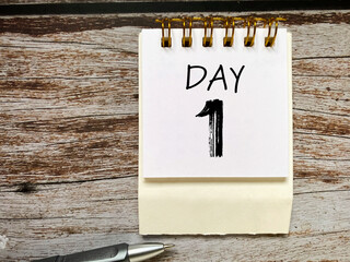 Day 1 text on note pad with copy space background. Stock photo. © Frederica Aban
