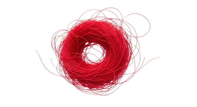 A tangled ball of bright red thread with loose strands extending outwards isolate yarn string craft textile material spool coil mess fiber hobby handmade