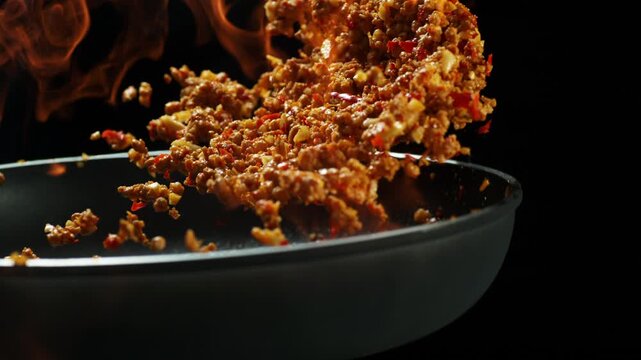 Fiery Thai basil pork chef tosses Pad Krapow Moo in blazing wok flames slow motion 4K
