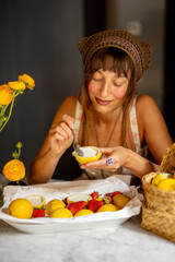 Woman tasting a homemade Sicilian lemon dessert in a cozy kitchen filled with fresh lemons, strawberries, and warm Mediterranean light.