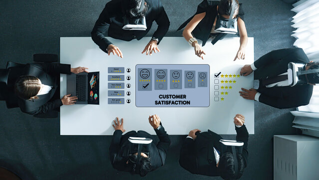 Aerial view of business professionals utilizing virtual reality headsets to assess customer satisfaction in a contemporary office meeting, fostering teamwork and innovation. Trope - Powered by Adobe