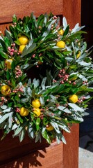 Lush citrus and berry wreath, mysterious Solstice festival decor, Yuletide charm, verdant portal to twilight celebrations