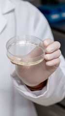 A gloved hand cradles a petri dish, a translucent universe of possibility, echoing science fair and Mole Day