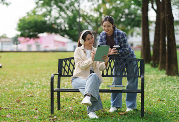 Young asian women studying online in park