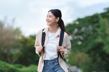 Asian girl student smiling walking in park