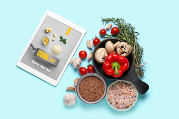 Digital recipe book, vegetables, spices and flax seeds on color background