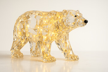 Crystal polar bear sculpture illuminated with warm golden LED lights, artistic glass animal decor glowing on reflective surface, winter festive decoration concept symbolizing strength purity arctic wi