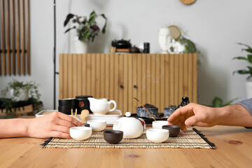 People during Chinese tea ceremony at home