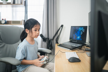 Young girl playing video games with excitement at home, focused on screen while sitting in...