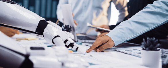 A modern workspace scene featuring collaborative interaction between a robot and human, showcasing technology's role in data analysis and strategic business development.Noogenesis