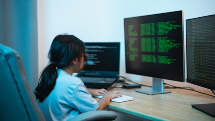 Young Girl Engaged in Programming and Coding Activities at Home with Multiple Computer Monitors...