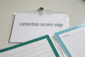 Transparent clip linking two sheets with connection secures edge text