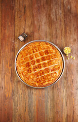 Delicious homemade savory pie with golden crispy layers, baked to perfection in a round tray. Perfect for family gatherings, traditional meals, or food photography showcasing authentic baked pastry.