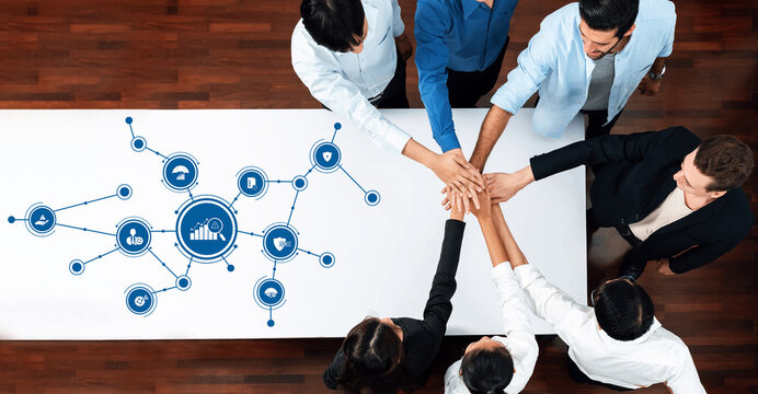 A diverse team collaborates on management strategies, showcasing teamwork and innovation in a modern office with a focus on data-driven insights for business growth. Amity