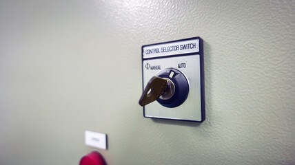 A switch key installed on a control panel is used to change operation modes between manual and automatic,