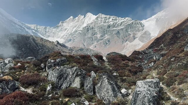 Rugged Himalayan terrain near Tilicho Lake in the Annapurna region of Nepal, with rocky slopes, alpine vegetation, and snow-capped peaks under a clear sky creating a dramatic mountain scene.