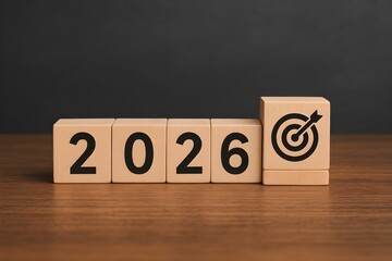 New year 2026 with wooden blocks symbolizing target business for the upcoming year. Represents planning, investment, and innovation as ideas move from the end of 2025 new year