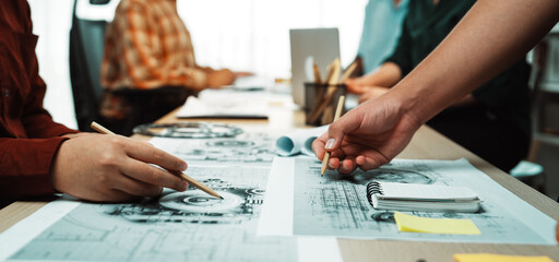 A dynamic scene in a design studio shows a diverse team engaged in sketching and collaboration,...