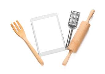 Digital recipe book with kitchen utensils on white background