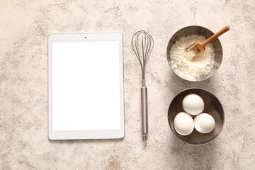 Digital recipe book with kitchen utensils and ingredients on white grunge background