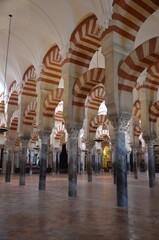 Cordoba, Spain 03.27.2019: Ceiling with double arches of white stone and red brick at the Prayer...
