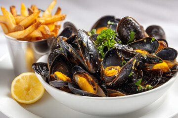 Freshly Prepared Mussels and Crispy French Fries on a Clean White Plate for Commercial Presentation