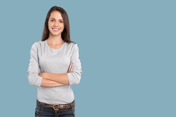 Smiling young woman posing on blue background
