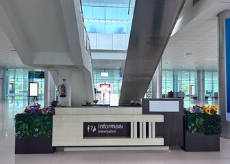 Information desk stands ready to assist travelers in a modern airport terminal, offering guidance and support with a welcoming and efficient atmosphere.