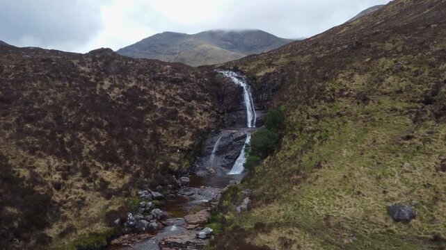 Drone footage flying over the majestic Eas a'Bhradain Waterfall in the Scottish Highlands