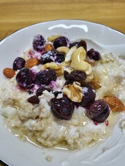 Healthy Breakfast of Yogurt Topped with Mixed Nuts and Drizzled Honey, Overhead View
