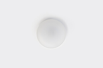 Minimalist Circular White Ceiling Lamp on White Background.