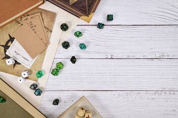 Tabletop role playing flat lay background with RPG dices, rule books, dungeon map on white wooden...
