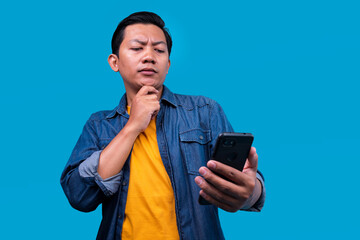 Thoughtful Asian Male Put Hand on Chin Thinking About Something to Browse on Internet