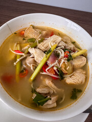 Savor the rich and aromatic flavors of traditional Thai Tom Kha Gai, a delightful coconut chicken soup brimming with tender chicken, exotic mushrooms, and vibrant herbs. A comforting and authentic