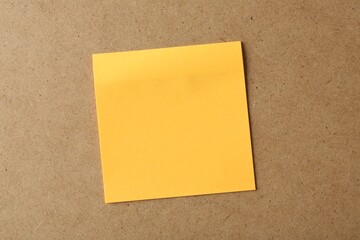 Blank orange note on cork board, space for text