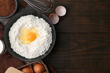 Ingredients for dough on wooden table, flat lay. Space for text