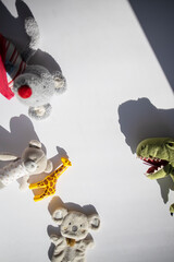 Children's Stuffed Toys with Strong Shadows on White Background.
